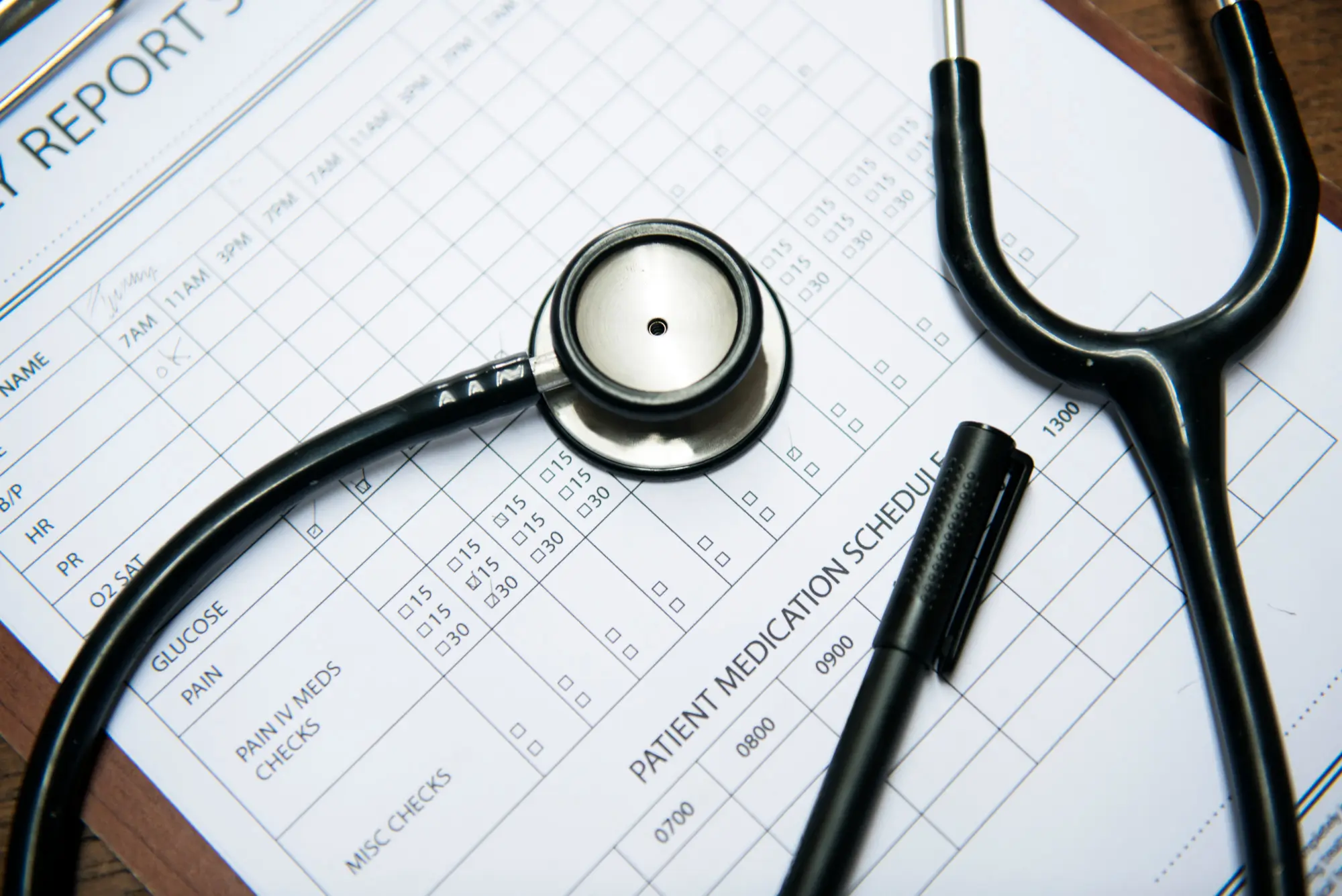 Nursing notes and a stethoscope on a patient care record